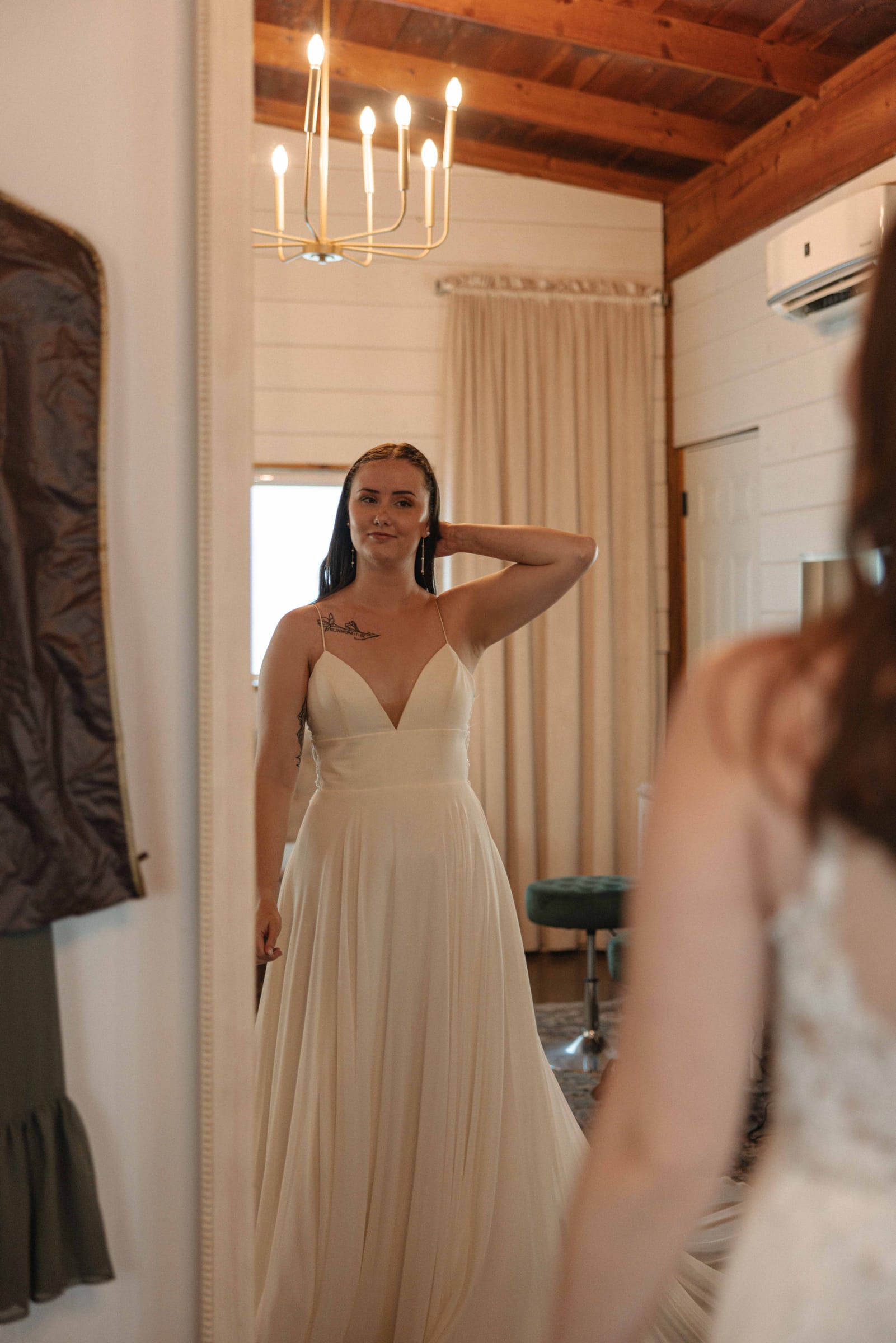 Bride admiring her reflection in the suite mirror