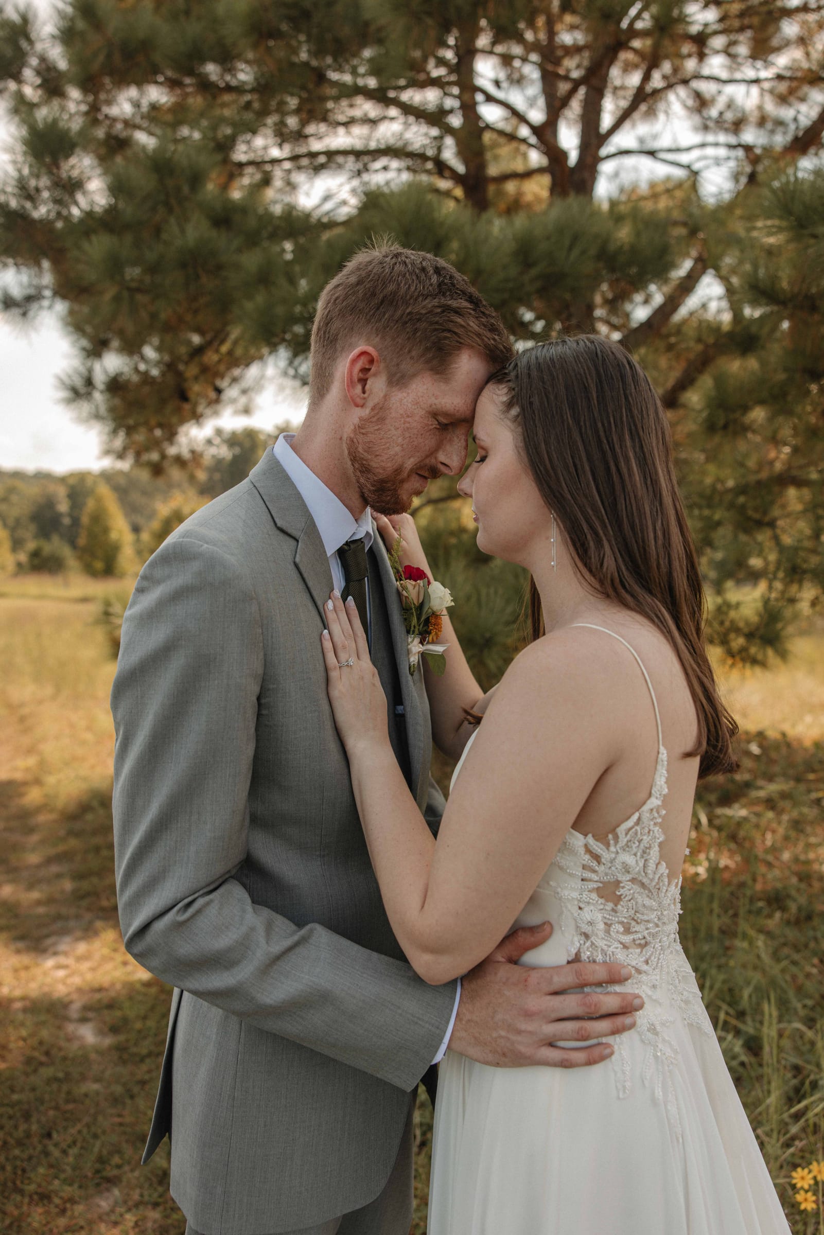 Bride and groom sharing a quiet forehead moment