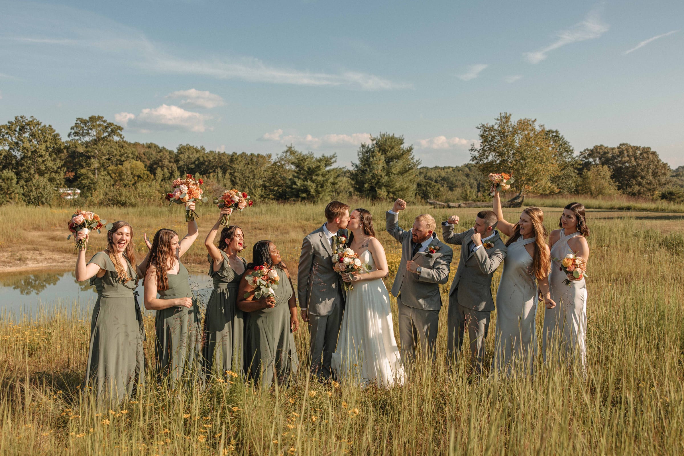 Full wedding party celebrating together in the meadow at Cedar Hills Farm