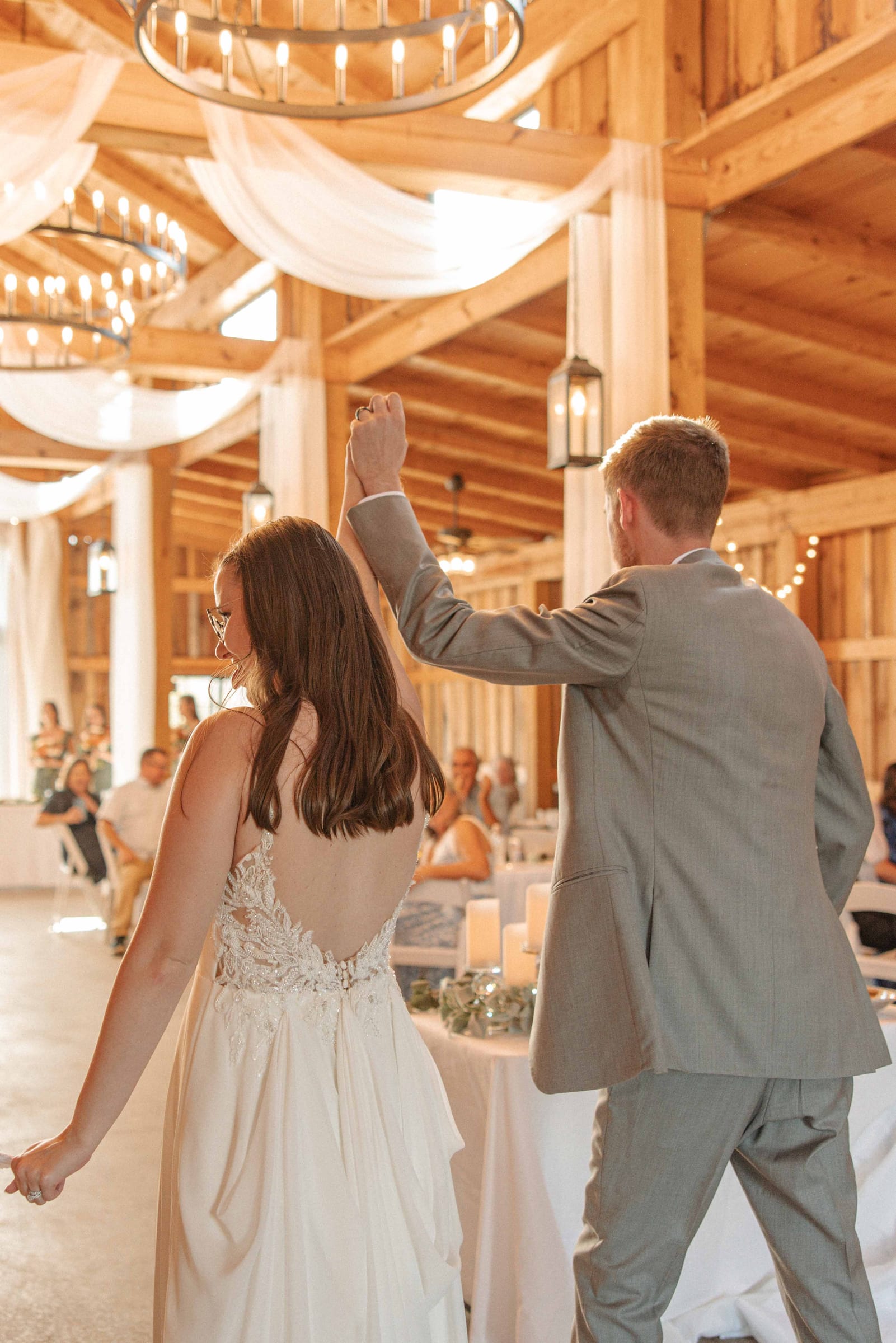 Groom spinning his bride on the dance floor inside the Cedar Hills Farm reception barn
